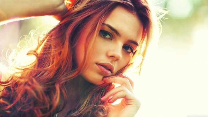 Woman with red hair and painted nails