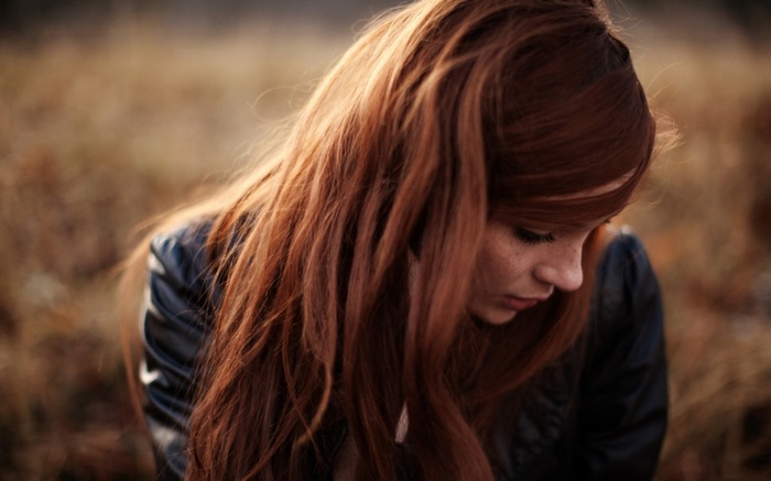 Woman with long red hair outdoors
