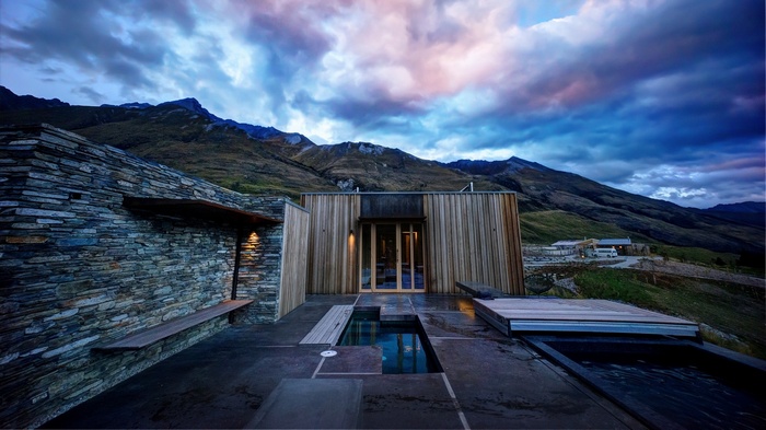Modern house with pools in mountainous landscape