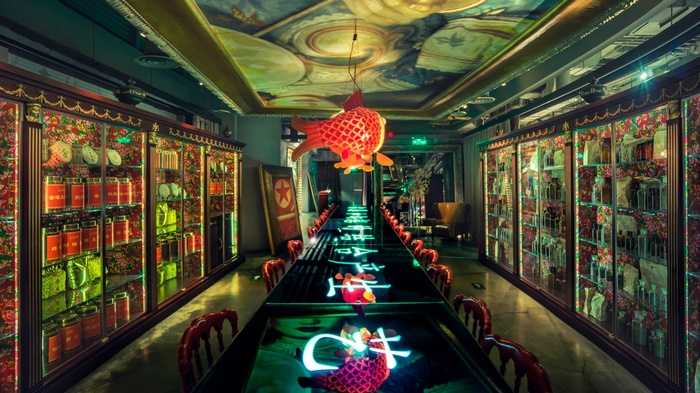 Long table with glowing Chinese characters and fish decorations