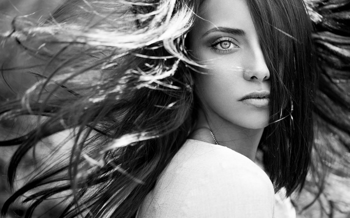 Monochrome portrait of a woman with windblown hair
