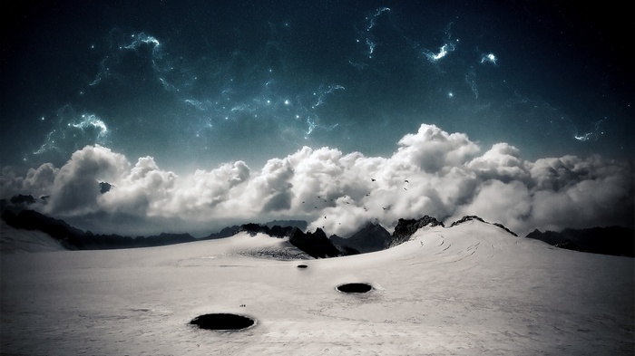 Snowy mountains under a starry, cloudy night sky