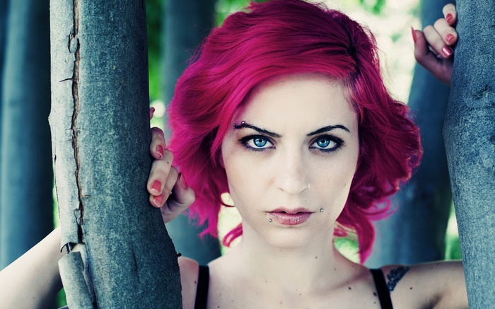 Woman with magenta dyed hair and blue eyes