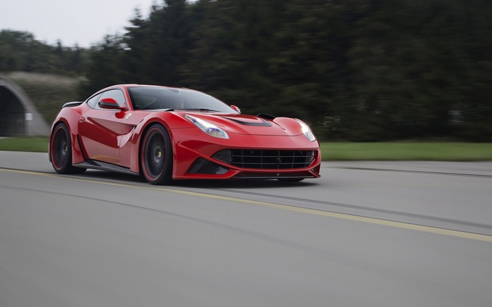 Red Novitec Ferrari F12tdf driving on a road