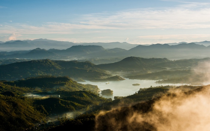 Misty mountains and a lake at sunrise