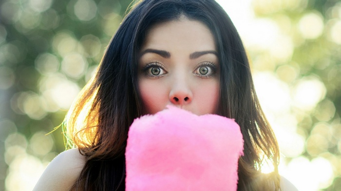 Woman eating pink cotton candy