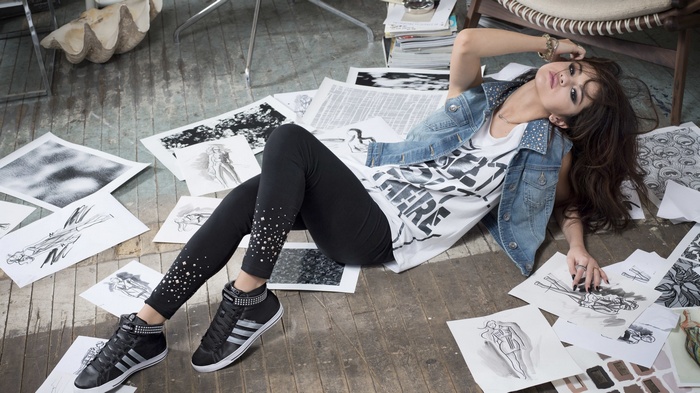 Selena Gomez on the floor with drawings