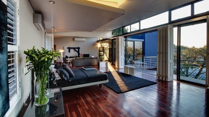 Modern bedroom with large windows and balcony