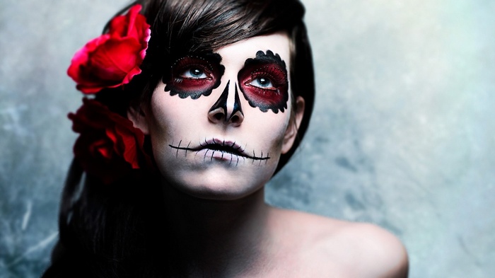 Woman with Sugar Skull makeup and red roses
