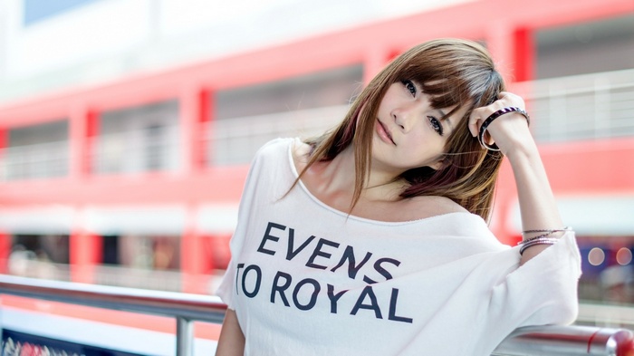 Asian woman with brown hair wearing a white shirt