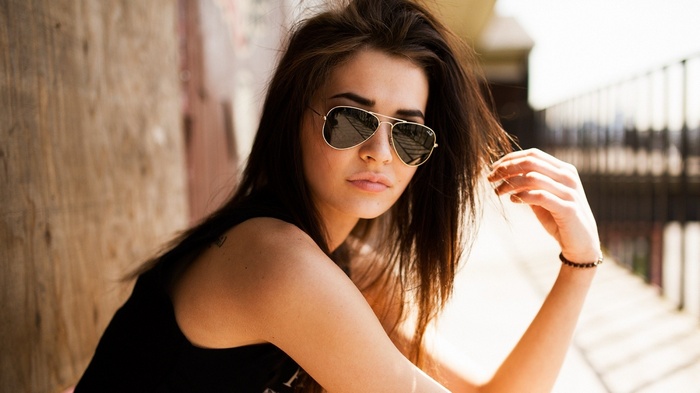 Woman wearing sunglasses and black top outdoors