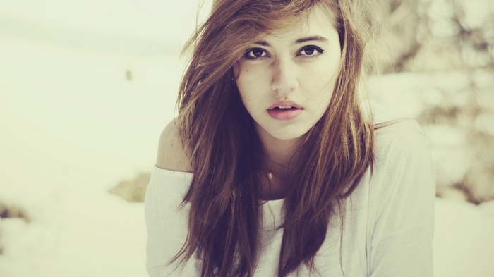 Portrait of a young woman with brown hair and brown eyes
