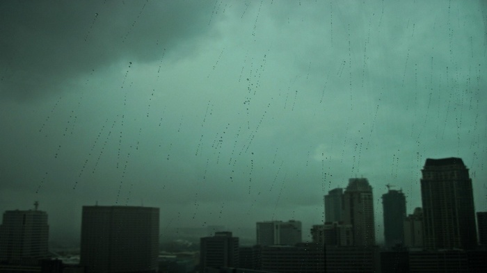 Rainy cityscape with dark clouds