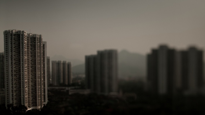 Blurred cityscape with tall apartment buildings