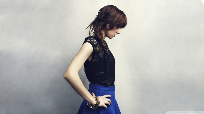 Christina Grimmie in a black top and blue skirt