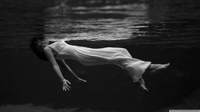Woman in a white dress underwater