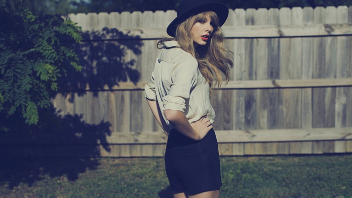 Taylor Swift wearing a hat and shorts