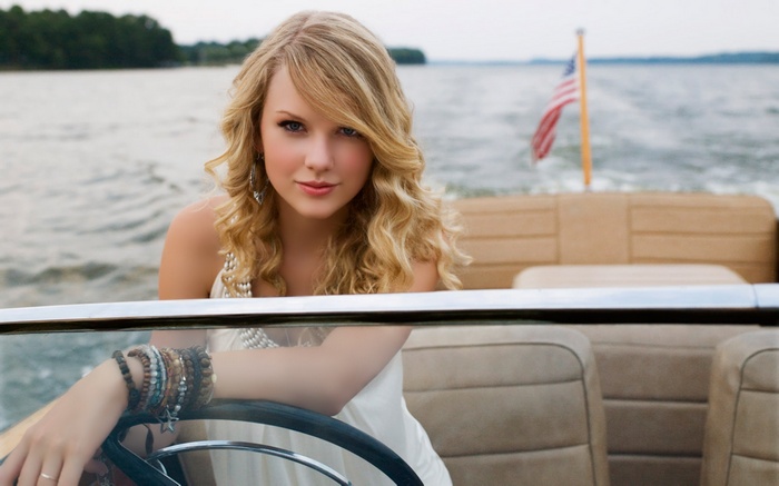 Taylor Swift on a boat with American flag