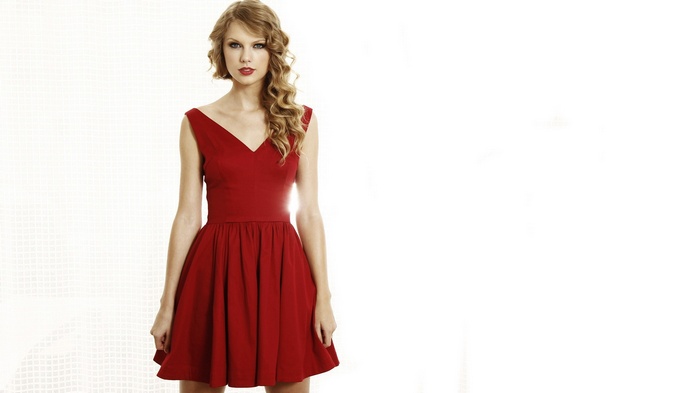 Taylor Swift in a red dress on a white background