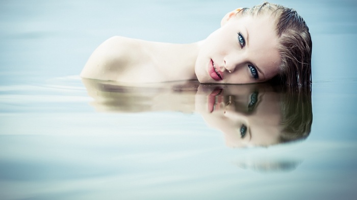 Woman with blonde hair in water with reflection