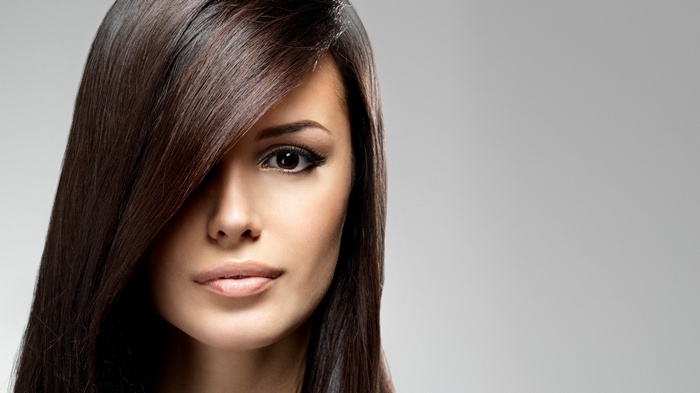 Woman with long dark hair and makeup