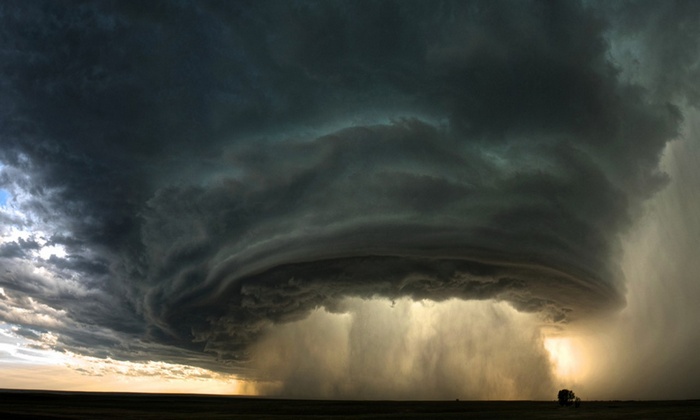A massive storm cloud with rain falling