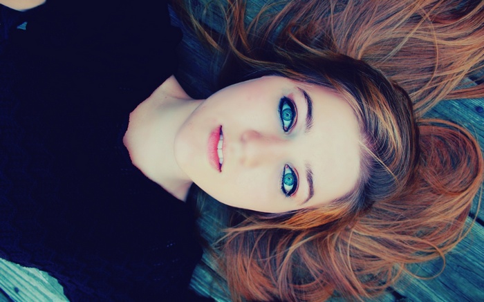 Woman with blue eyes lying down