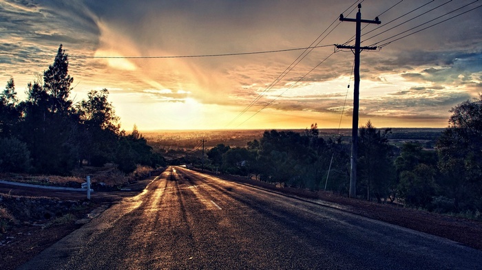 Road leading to sunset over a valley