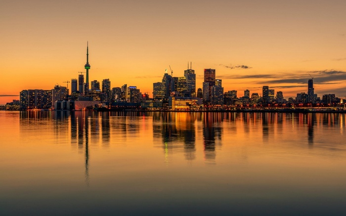Toronto skyline at sunset with water reflection