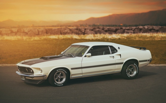 White 1969 Ford Mustang Mach 1 parked at sunset