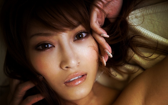 Asian woman with brown hair and makeup