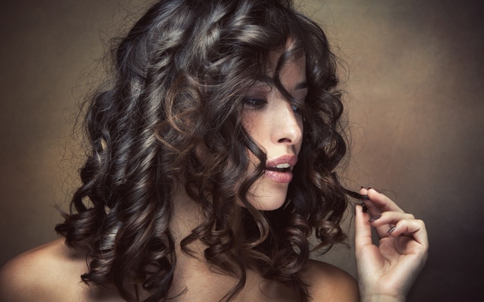 Woman with curly brunette hair