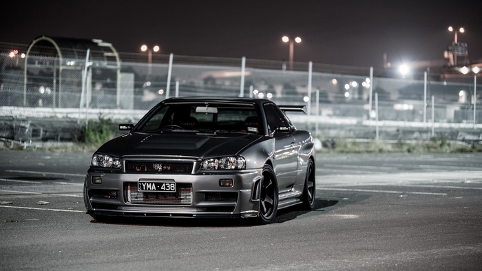 Silver Nissan Skyline R34 parked at night