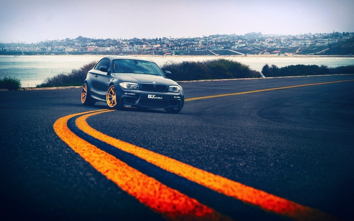 Black BMW 1 Series M Coupe on Coastal Road