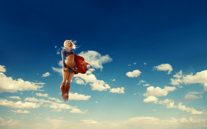 Supergirl flying in the sky with clouds