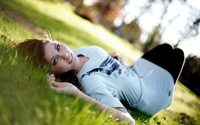 Woman lying on grass outdoors