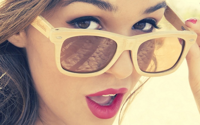 Woman wearing Woodies sunglasses with red lipstick