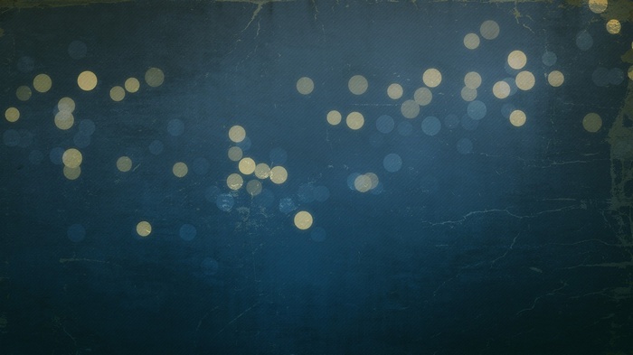 Abstract bokeh lights on a textured dark blue background