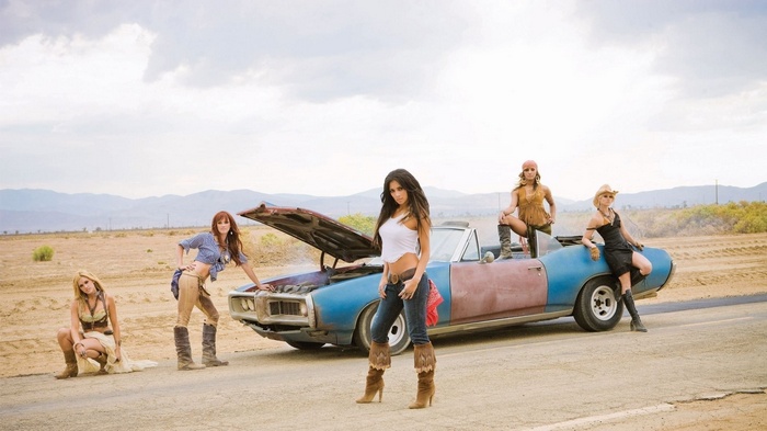 The Pussycat Dolls with a broken-down car in the desert