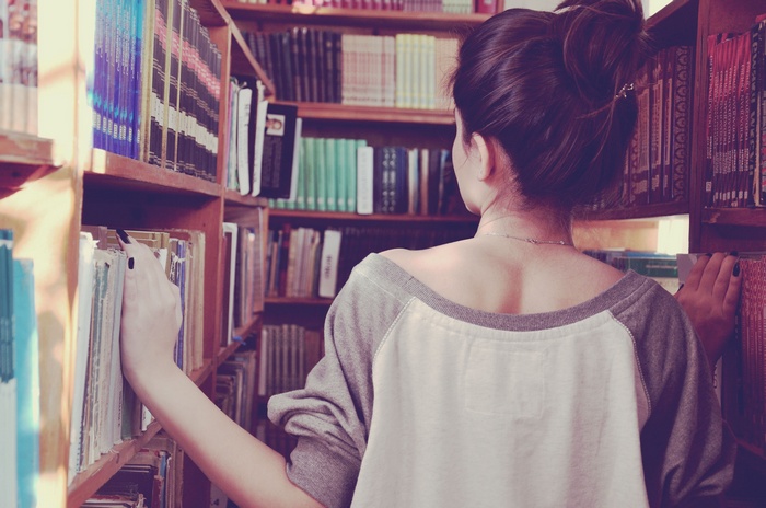 Woman browsing books in a library