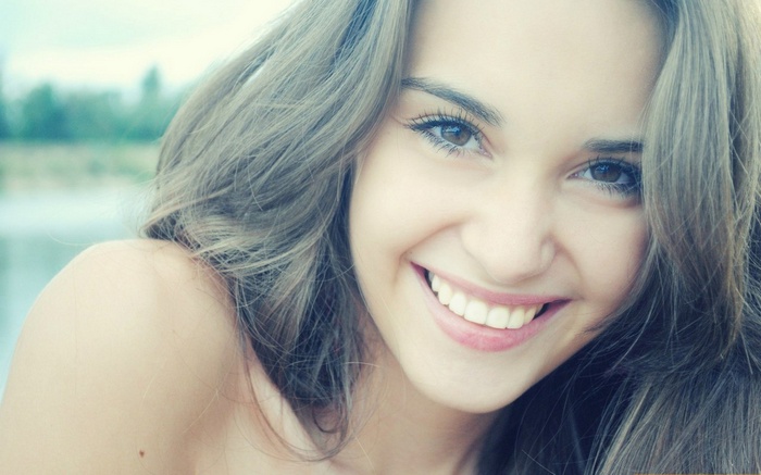 Young woman smiling outdoors