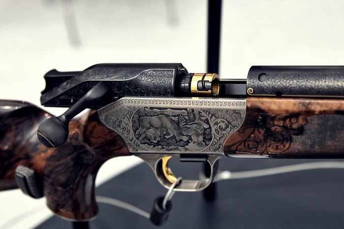 Engraved rifle with wooden stock