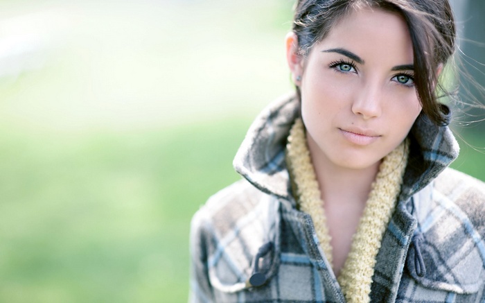 Woman wearing a plaid coat and scarf