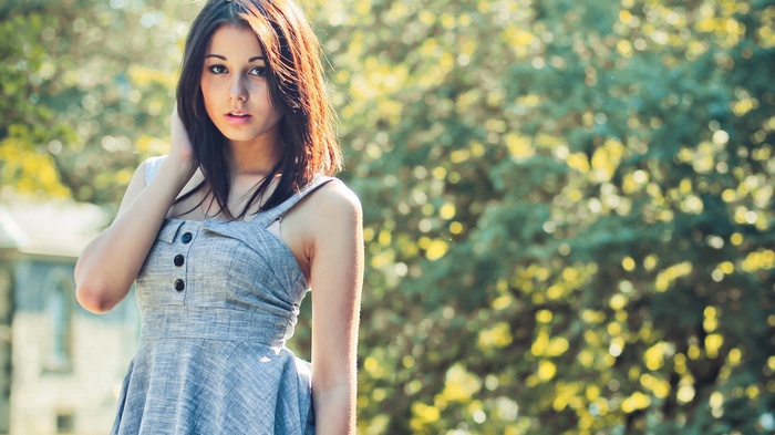 Laura Baduria in a grey dress outdoors