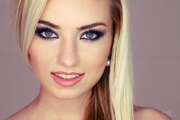 Woman with blonde hair and makeup