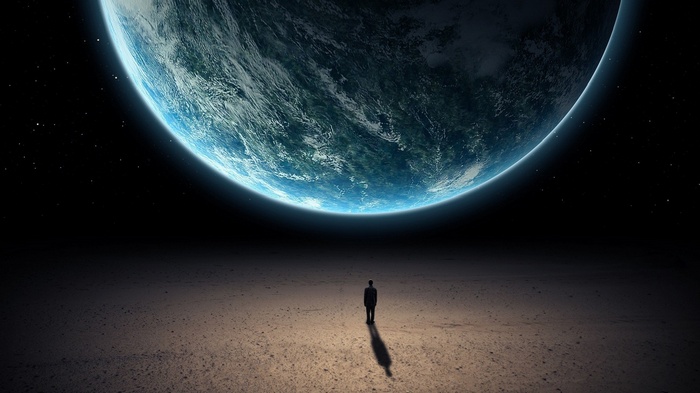 Man standing on a barren planet looking at Earth