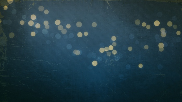 Bokeh circles on a dark textured background
