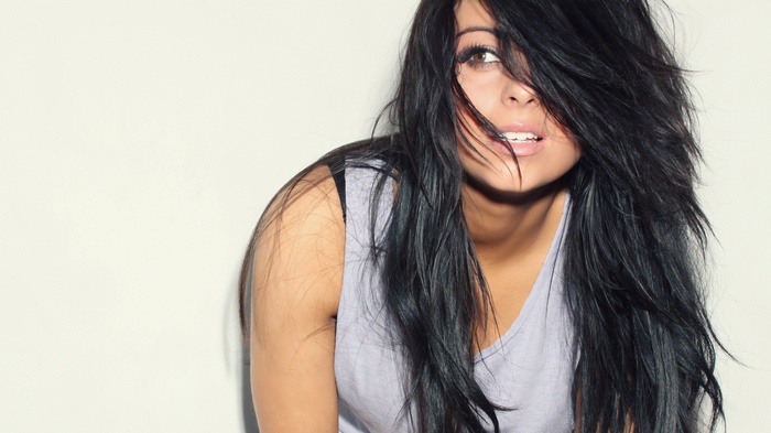 Woman with long black hair wearing a tank top