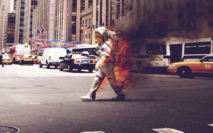 Astronaut on fire crossing a city street