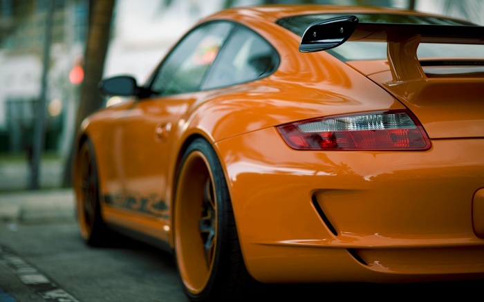 Orange Porsche 911 GT3 parked on a street